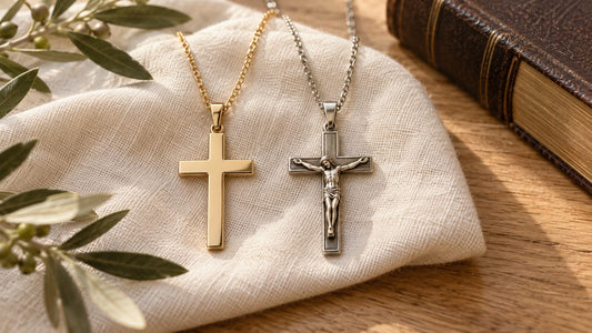 Cross necklace and crucifix necklace displayed side by side beside a Bible