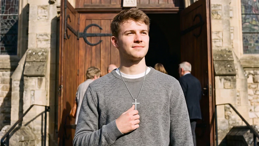 Christian wearing a cross necklace outside a church